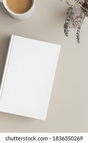 White Book Mockup With A Cup Of Coffee And Lavender On A Beige Table.