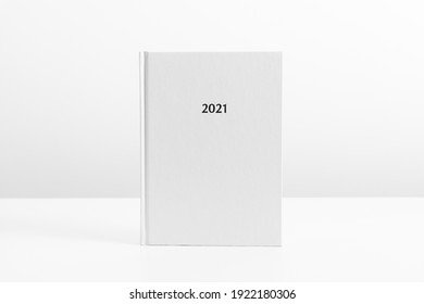 White Book Mockup, Diary For 2021, White Table. Front View. Place For Text, Copy Space, Mockup
