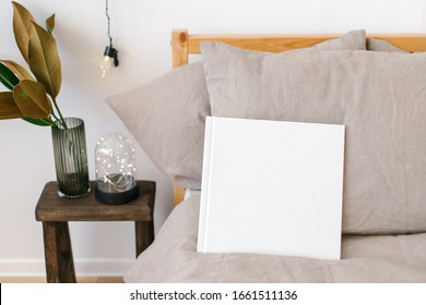 White Book Mockup. Square Empty Book. Album With Clean Pages. White Book Cover Mockup On The Bed In Scandinavian Style