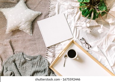 White Book Mockup. Square Empty Book. Album With Clean Pages On The Bed With Pillow, Sweather And Coffee. Clean Book Cover Mockup. Flat Lay With Mockup Of The Book. Lifestyle Picture With White Album.