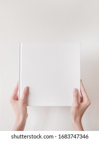 White Book Mockup. Square Empty Book. Album With Clean Pages In Hands Of Woman. Clean Book Cover Mockup