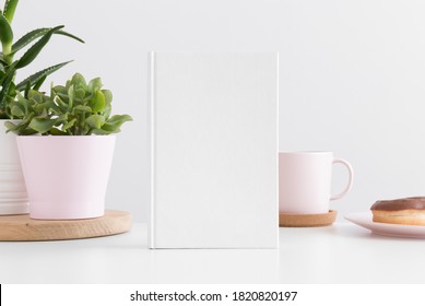 White Book Mockup With Succulent Plants In  Pots, Clock And Workspace Accessories On A White Table.