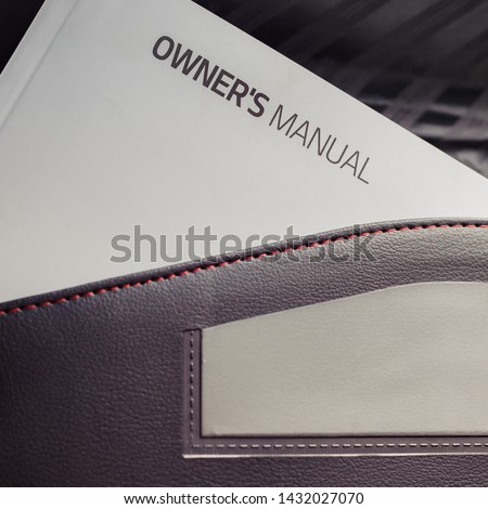 A white book placed in all new vehicles called an owner's manual usually placed in a black leather pouch located inside the glove compartment. 