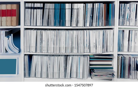 White Bookcase With Many Reports, Magazines Or Other Publications