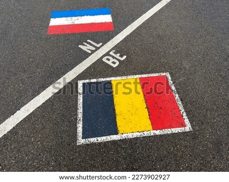 White borderline between Netherlands and Belgium on road. Benelux. Border, part of a Serie.