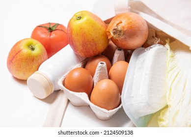 White Bottle, Apples, Onion, Tomato, Chinese Cabbage, Quark, Eggs In Tote Bag On White Background Spring Fresh Products Vegetables