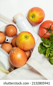 White Bottle, Apples, Onion, Tomato, Dill, Quark, Eggs In Tote Bag On White Background Close Vertical Spring Fresh Products Vegetables