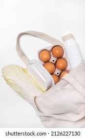 White Bottle, Chinese Cabbage, Quark, Eggs In Tote Bag On White Background Spring Fresh Products Vegetables