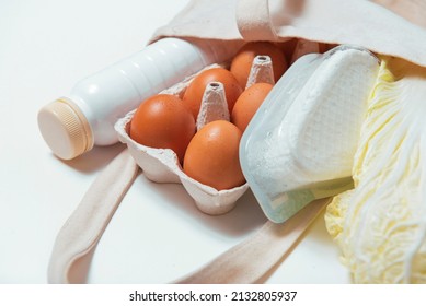 White Bottle, Chinese Cabbage, Quark, Eggs In Tote Bag On White Background Side Look Spring Fresh Products Vegetables