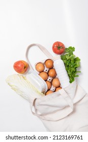 White Bottle, Chinese Cabbage, Tomato, Apple Dill, Quark, Eggs In Tote Bag On White Background Vertical Spring Fresh Products Vegetables