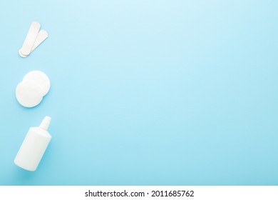 White Bottle Of Hydrogen Peroxide, Cleansing Cotton Pads And Adhesive Bandages On Light Blue Table Background. Pastel Color. Medical Kit For Skin Wound Cleaning. Empty Place For Text.