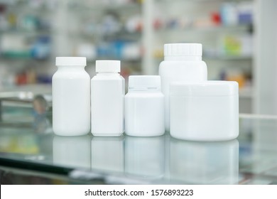 White Bottle Medicine On Counter And Shelf Medicine In Pharmacy Background