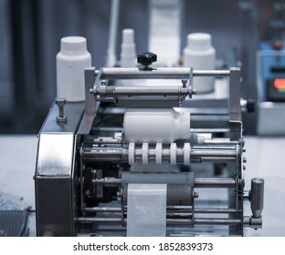 White bottle on labeling machine in pharmaceutical industrial