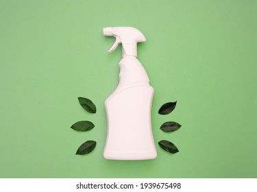 White bottle with spray bottle and green leaves on a green background. Organic detergent with natural extract for eco-friendly spring cleaning, logo mockup, advertising, organic detergent.top view. - Powered by Shutterstock