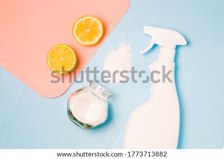 a white bottle of spray without a label, half lemon and lime, sprinkled soda and a glass jar of soda, eco-friendly non-toxic home cleaning products, zero waste lifestyle