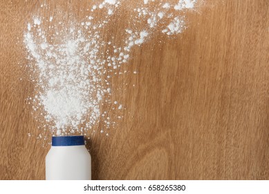 White Bottle Of Talcum Powder Splash On Table Wood , Health Concept Background