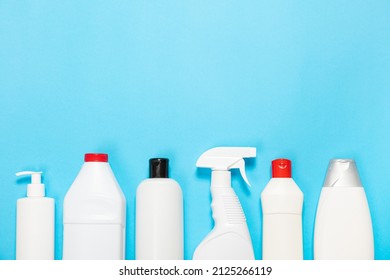 White Bottles Of Cleaning Agent On A Blue Background On The Side. Professional Cleaning Products, General Cleaning. Household Chemicals Top View