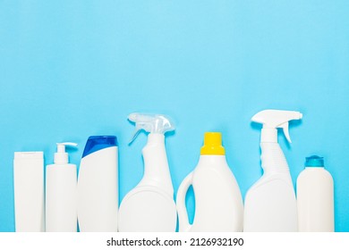 White Bottles Of Cleaning Agent On A Blue Background On The Side. Professional Cleaning Products, General Cleaning. Household Chemicals Top View