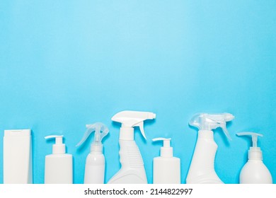 White Bottles Of Cleaning Agent On A Blue Background On The Side. Professional Cleaning Products, General Cleaning. Household Chemicals Top View