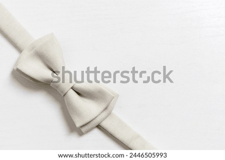 White bow tie for a child on a light background, Newborn. Birthday, father's day concept