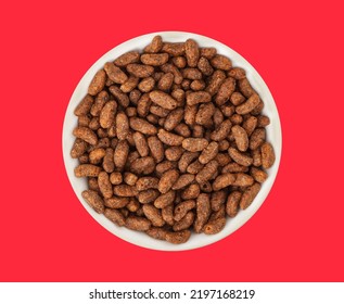 White bowl with natural organic granola cereal chocolate flakes on red background. Oven-toasted rice cereal and the flavor chocolate. Top view