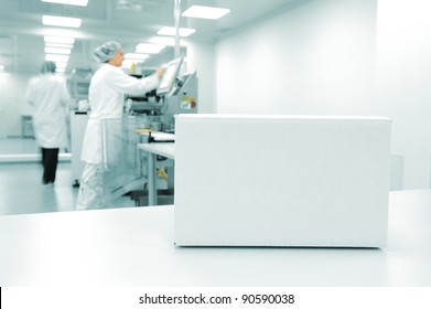 White Box At Automated Production Line At Modern Factory, People Working In Background