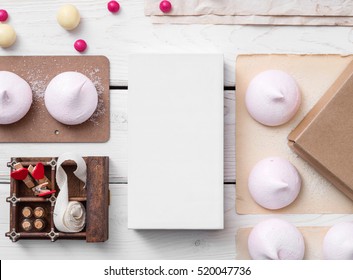 White Box Mockup Between Different Sweets On The Table And Figures