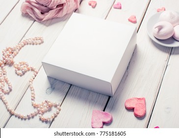 White Box Mockup Next To Different Heart Shapes And Sweets