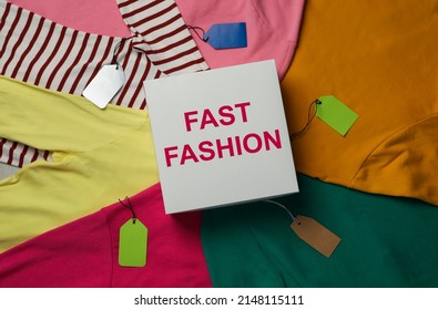 White Box With Phrase Fast Fashion And Different Clothes, Top View