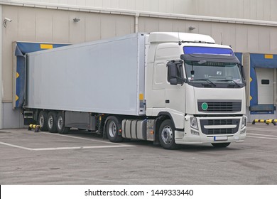 White Box Semi Trailer At Warehouse Loading Bay Dock