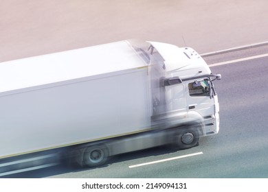 White Box Truck Driving Fast With Blank Space For Text On A Highway City Road.