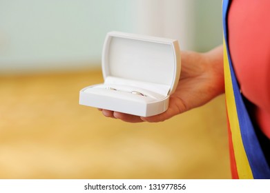 white box with wedding rings in hand - Shutterstock ID 131977856