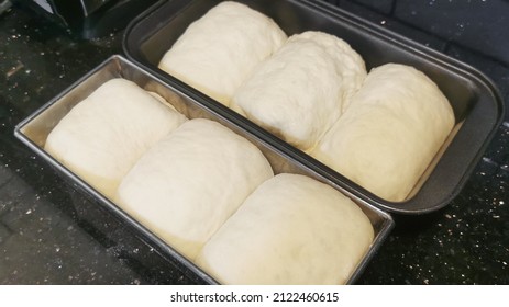 White Bread Dough In Long Loaf Baking Tin.