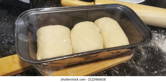 White Bread Dough In Long Loaf Baking Tin.