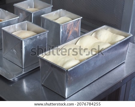 white bread dough in square and rectangle aluminum baking tin mold