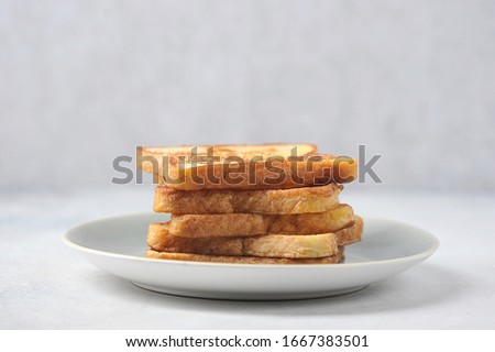 White bread toasts on a plate. Light background. Close-up. Free space for text.