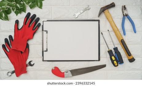 White brick background and tools.Blank paper and clipboard. - Powered by Shutterstock