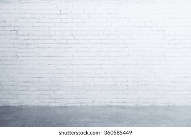 White Brick Wall And Concrete Floor In Empty Room