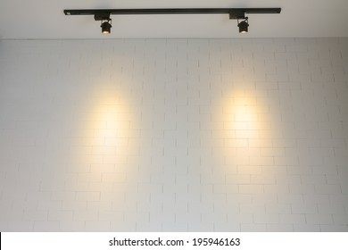 white brick wall with track  light