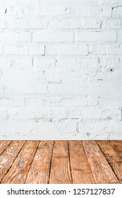 White Brick Wall And Wooden Table