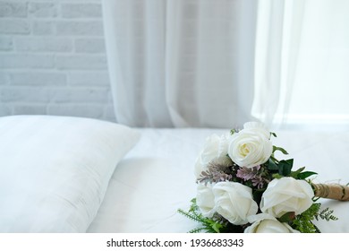 White Bridal Wedding Rose Flower Bouquet On Bed Beside See Through Sheer Window Curtain