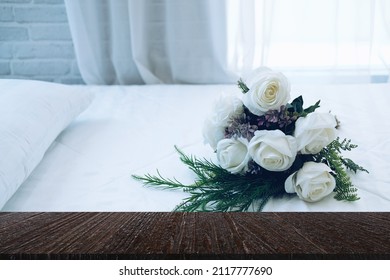 White Bridal Wedding Rose Flower Bouquet On Bed Beside See Through Sheer Window Curtain