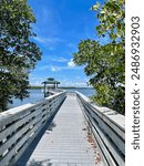 White bridge leading to a hutch over the water