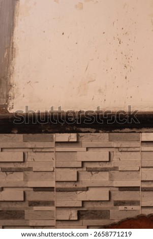 A white and brown abstract background featuring a rough, texture a wall or surface with clear variations in light and shadow across its entirety