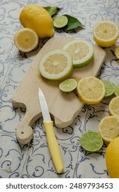 A white and brown cutting board with multiple colorful slices of vegetables and a knife resting on it
