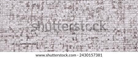 White and brown fluffy background of soft, fleecy cloth. Texture of textile closeup.