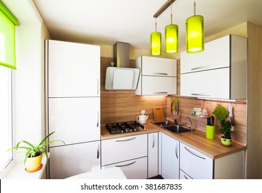 White and brown interior with green accessories foe small kitchen - Powered by Shutterstock