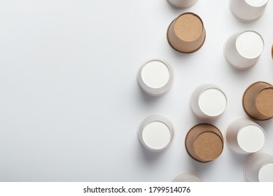 White And Brown Paper Cups Flipped Upside Down On A Light Background. Top View, Flat Lay