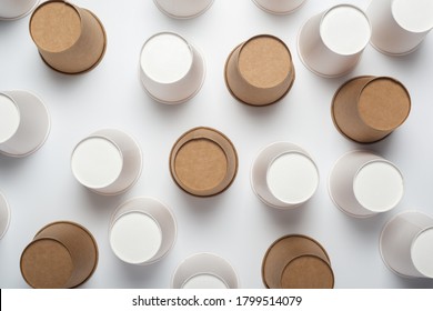 White And Brown Paper Cups Flipped Upside Down On A Light Background. Top View, Flat Lay