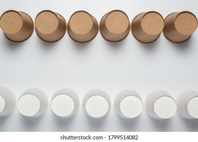 White And Brown Paper Cups Flipped Upside Down On A Light Background. Top View, Flat Lay